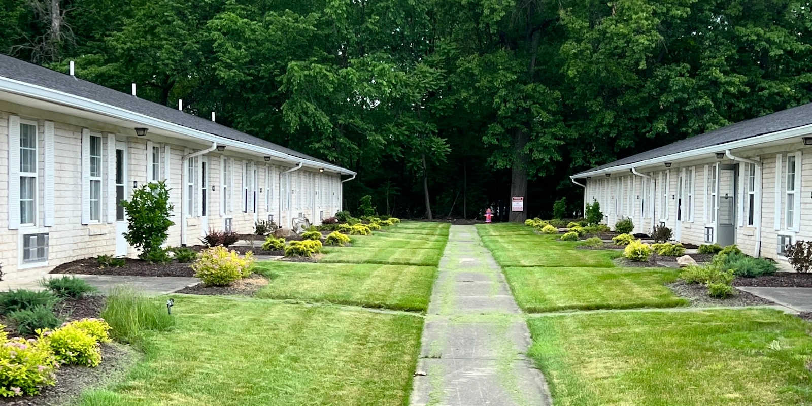 Well-maintained common access walkways to individual cozy apartment units